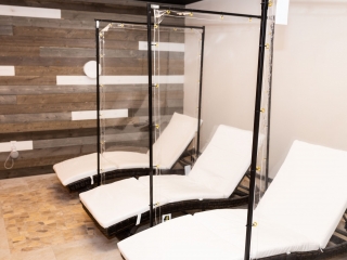 Three White Chaises With Three Clear Dividers At The Sharper The Medical Spa In Fishers, Indiana