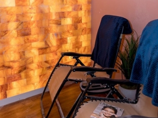 Sweet Be Wellness And Skin Clinic. 2 Lounge Chairs Both With Towels Draped Over The Back, Face Salt Tiled Wall. Magazine Is Placed On Lounge Chair Closest To Camera.