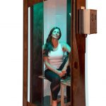 Woman sitting in Salt booth chamber