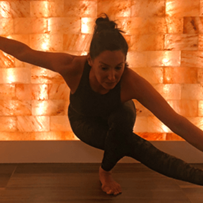 Woman In Front Of A Led Backlit Salt Panel Doing Yoga At The Bergamos Retreat - Friendswood, Texas.