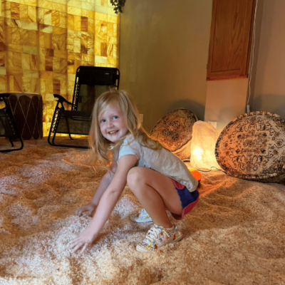 a child experiencing the respiratory benefits of salt therapy in a salt room