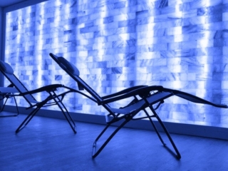 Lounge Chairs In Front Of A Salt Brick Wall Backlit By Led Light At Boca Cryo In Boca Raton, Florida