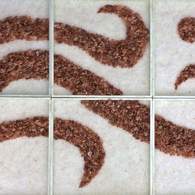 Three Different Sized Waves Of A Reddish Salt With Three Circles In The Top Right Hand Corner On A Bed Of White Salt.