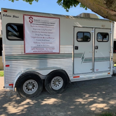A Mobile Silver Star Trailer With A Banner That Reads &Quot;Salt Chamber, Pioneers Of Equine Salt Therapy&Quot;