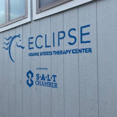 An Outer View Of The Wall At Eclipse Equine Sports Therapy Center, With A Sign That Reads Eclipse Equine Sports Therapy Center Powered By Salt Chamber