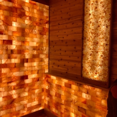 Orange Backlit Salt Stone Walls With A Wooden Panel Décor On The Wall In The Corner.