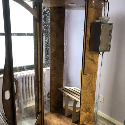 Open wooden and glass halotherapy booth at the Healing Arts NYC Original SALT Booth in New York
