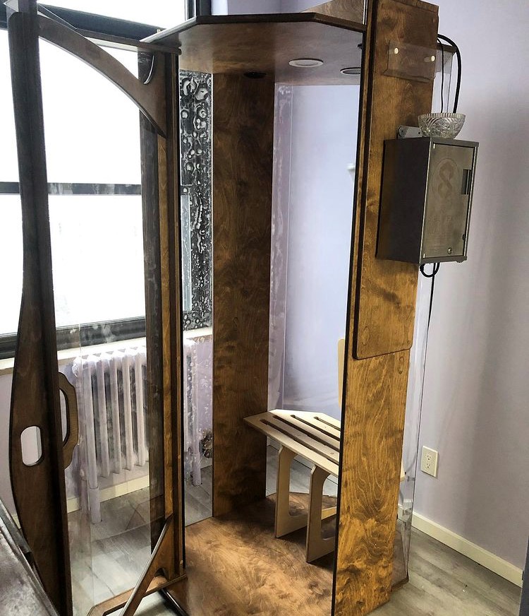 Open wooden and glass halotherapy booth at the Healing Arts NYC Original SALT Booth in New York