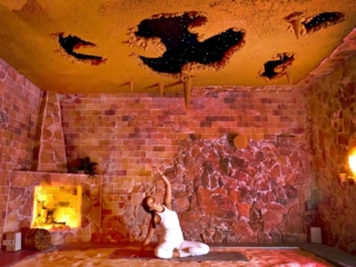 Woman Doing Yoga On A Yoga Mat On A Salt-Covered Floor In A Salt Cave At The Healing Salt Cave &Amp; Wellness Spa - Guilford, Connecticut.