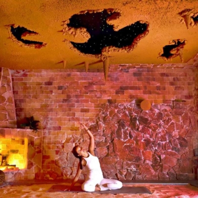 Woman In A Salt Cave Doing Yoga On A Mat On A Salt-Covered Floor At Healing Salt Cave &Amp; Wellness Spa - Guilford, Connecticut.
