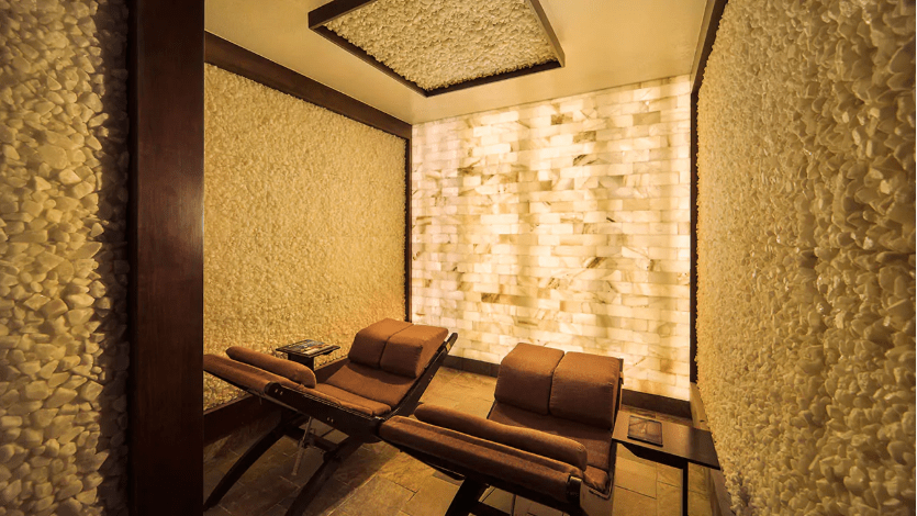Two Brown Lounge Chairs In A Room Surrounded By White Salt Panel Walls And A White Led Back Lit Salt Brick Wall At The Hyatt Regency Scottsdale Spa Avania.
