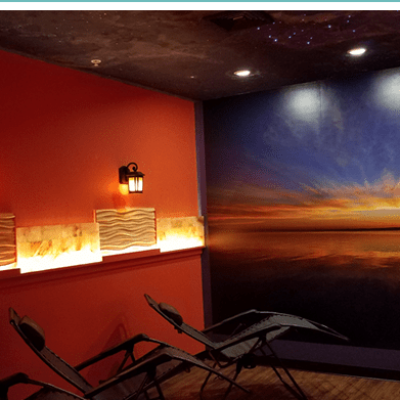 Two Reclined Chairs Facing A Sunset Decor Wall In An Salt Therapy Room At Just Breathe Salt Spa In Hyannis, Massachusetts