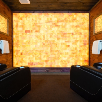 Two Black Chairs Facing A Led Backlit Salt Panel With Four Rectangular Led Backlit Salt Brick Wall Décor At Larose Muscular Therapy - Milford, Massachusetts.