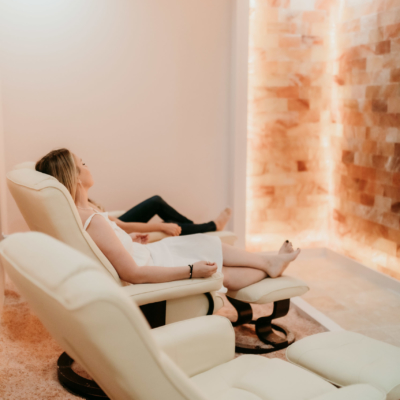 Person Relaxing In A Salt Room With A Salt Brick Wall By Salt Chamber