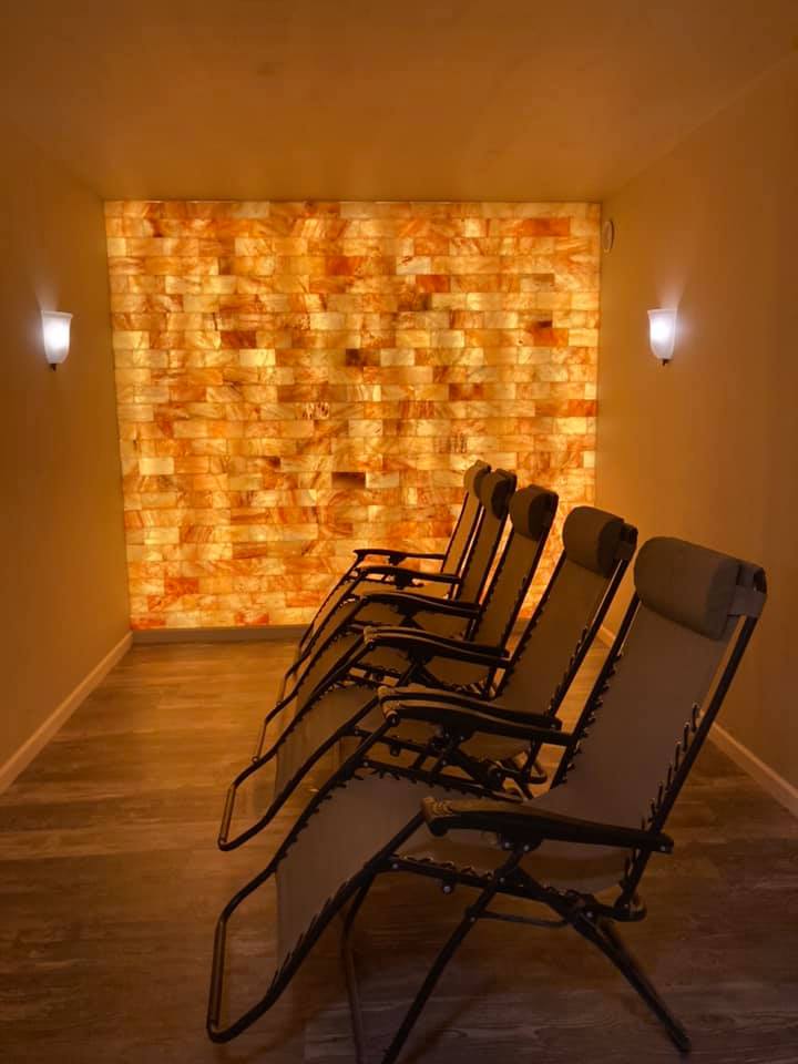Five Chairs In A Grey Room With A Led Backlit Salt Panel At Restoring Eden - Gilsum, New Hampshire.