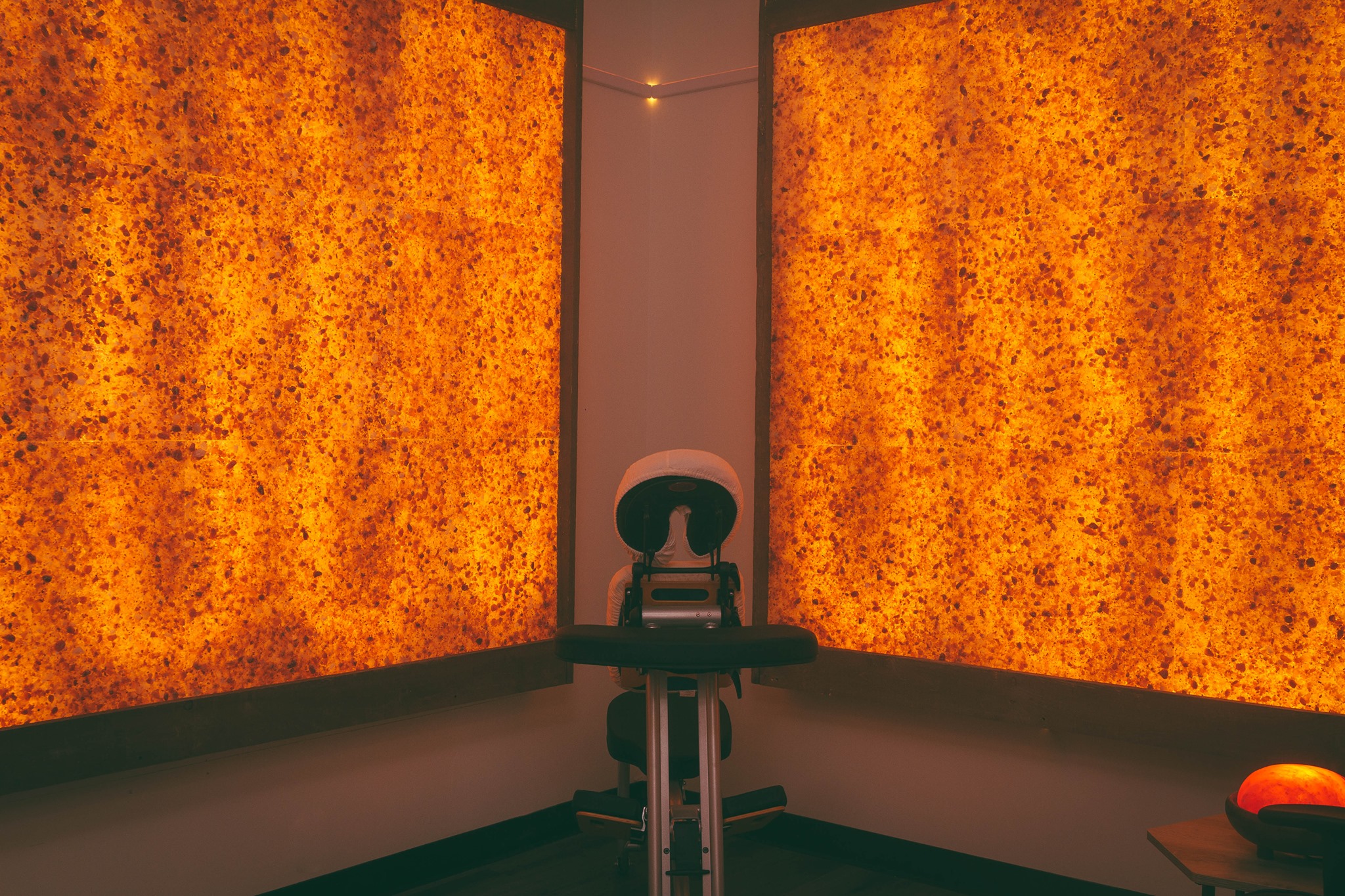 A Massage Chair With Two Large Led Backlit Salt Brick Walls At The Revelations Holistic Center - Dorval, Quebec.