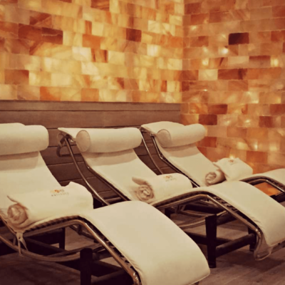 Three White Chaises All With Towels Surrounded By Himalayan Salt Stone Walls At Salinity.