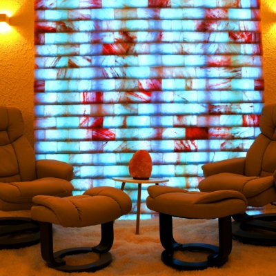 Two Tan Cushioned Chairs On A Salt-Covered Floor And Blue Backlit Salt Stone Wall.