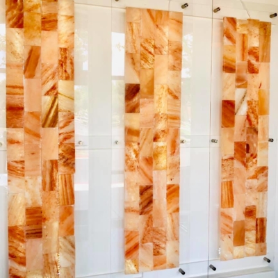 Three Himalayan Salt Stone Panels With Glass Against A White Wall.