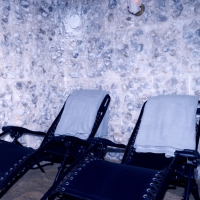 Two dark blue lounge chairs in front of a salt panel wall at The Nordic Edge in Eastchester, New York