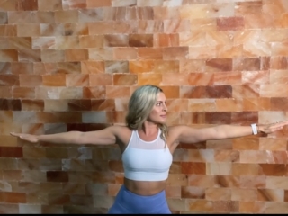 Woman Doing Yoga In Front Of A Himalayan Salt Panel Wall At The The Salt Center - Alpharetta, Georgia.