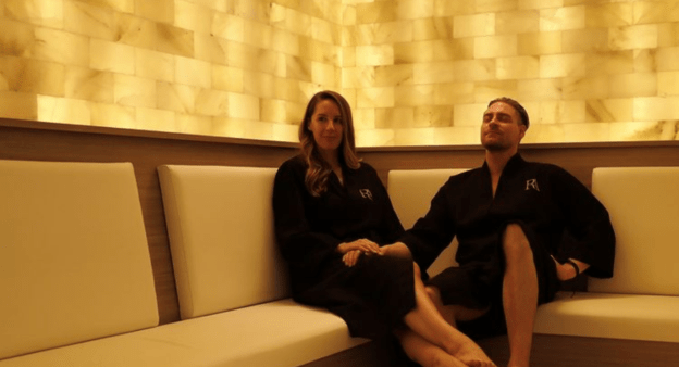 Couple relaxing in a salt room with yellow ambient lights