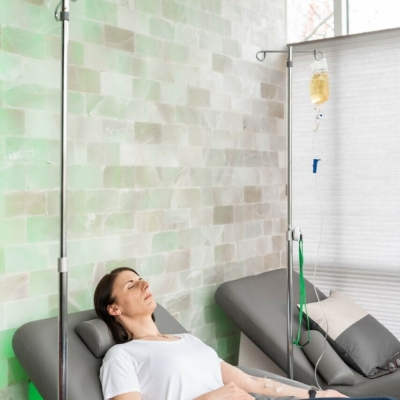 Women relaxing in a Curvalounger by Oakworks while she receives IV Therapy in a Salt Room