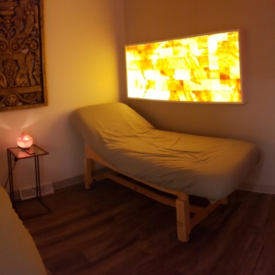 Two Massage Tables With Three Rectangular Backlit Décor, Two With Orange Lighting And One With Red Lighting, At The Yellow Canary Health Spa In Glidden, Iowa