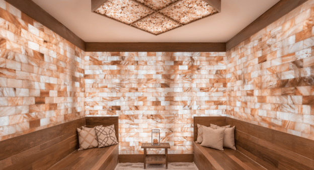 A salt room, perfectly suited for salt room therapy with salt brick walls, salt panels, and a halogenerator at Palm Heath Salt Room.