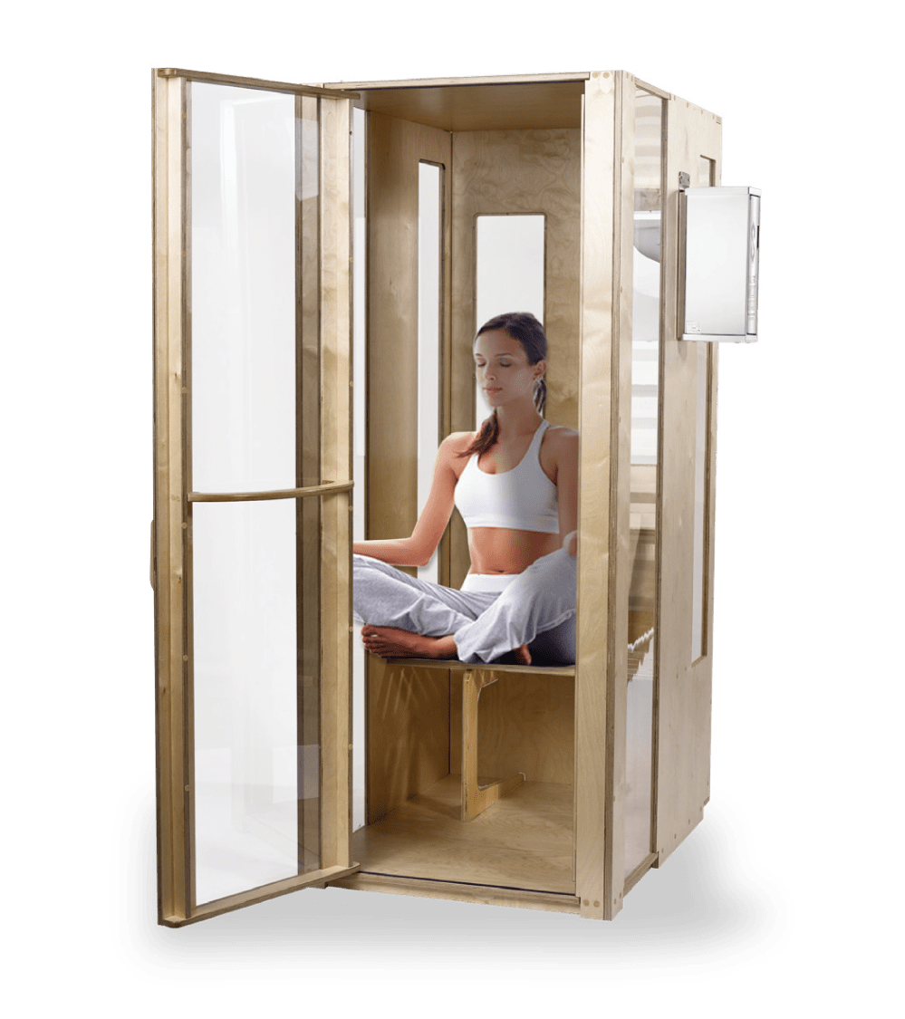 Woman sitting in a meditation posture in Salt booth chamber