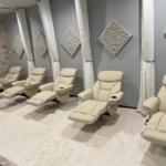 The salt room at NexGen Fitness in Buffalo, New York with chairs, Himalayan salt panels, and Himalayan salt bricks on the wall.