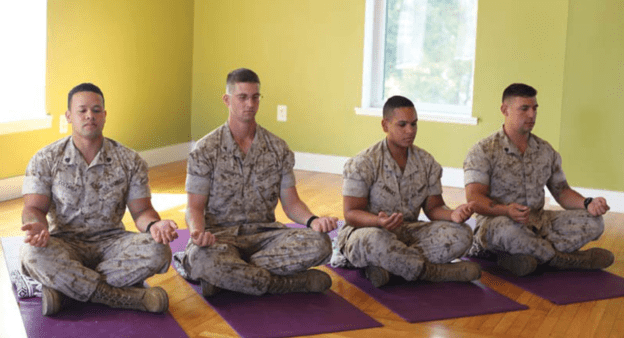 Veterans Doing Yoga, Meditation Mindfulness, And Breathwork In A Salt Room To Combat Respiratory Conditions And Enhance Mental Wellness.