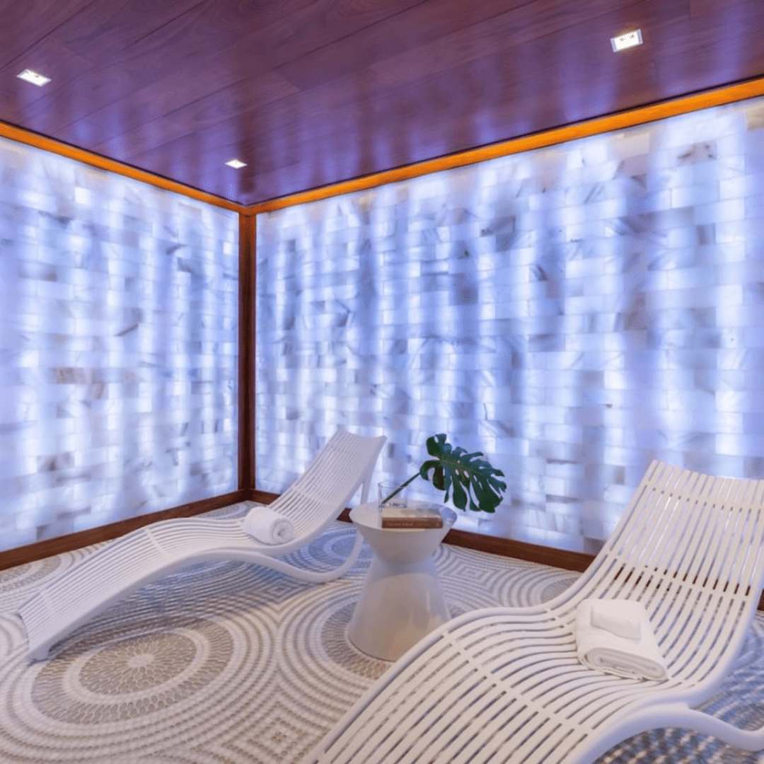 The salt room at the Alina Residences in Boca Raton, Florida with two chairs and Himalayan salt brick walls.