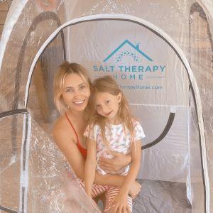 Image Of A Woman And Her Daughter During A Salt Therapy Session In The Salt Therapy Home Pop Up Salt Booth With Home Halogenerator. | Salt Chamber
